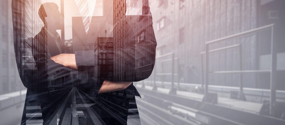 Double Exposure Image of Business Person on modern city background. Future business and communication technology concept. Surreal futuristic cityscape and abstract multiple exposure graphic interface.