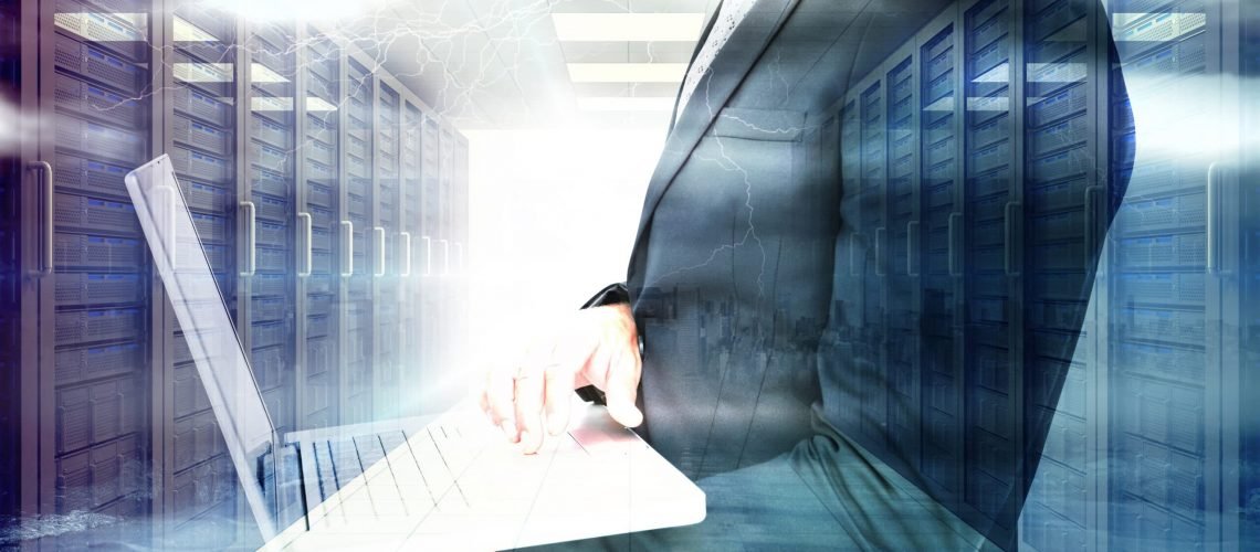 Businessman holding laptop against stormy sky with tornado over road